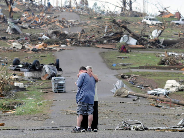 A mother comforts her son in Concord, Alabama, near his house which was completely destroyed by a tornado in April of 2011.