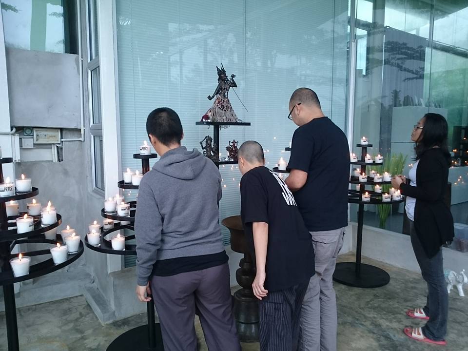 Lighting candles at Rinpoche's outdoor Vajrayogini butter lamp shrine after the teachings. Picture courtesy of Martin Chow (http://www.facebook.com/martin.chow.73)